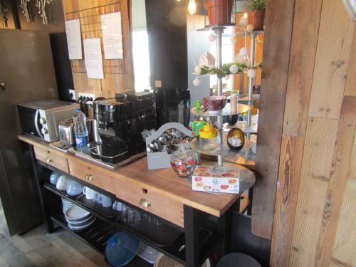 a kitchen with a wooden counter with a coffee maker at Chambre d'hôtes Au Nid du Thil in Beauvais