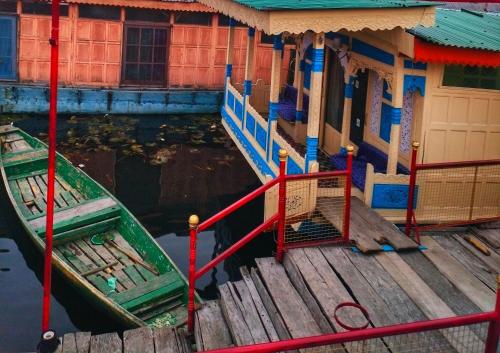 two boats are docked next to a building at Lala Rukh Group Of Houseboats in Srinagar