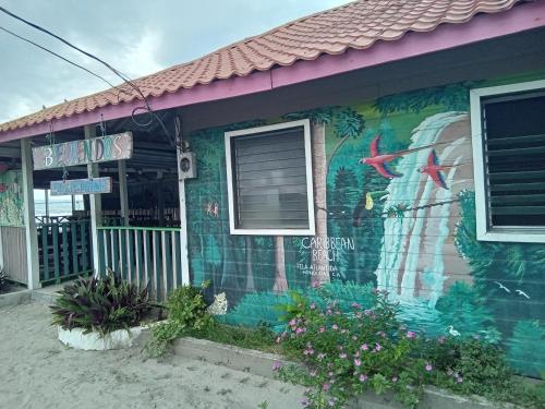 a house with a painting on the side of it at Hostel Casa Verde, Tela Atlantida. in Tela
