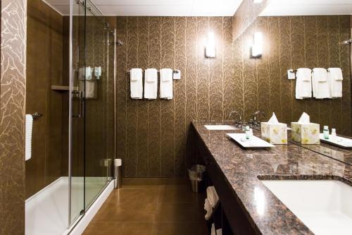 uma casa de banho com um lavatório e um chuveiro em Hotel Blackfoot em Calgary