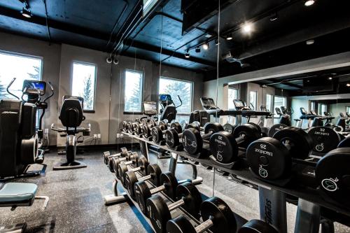 a gym with rows of dumbbells and other equipment at Hotel Blackfoot in Calgary