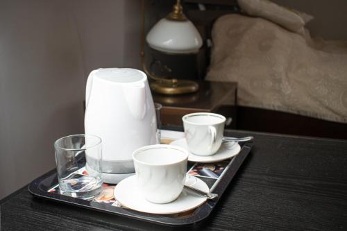 a tray with two cups and a glass on a table at Stacja Miśków in Wilków Nowy