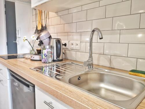 a kitchen with a sink and a counter top at Bulles de sommeil - Cozy - RBNB in Mulhouse