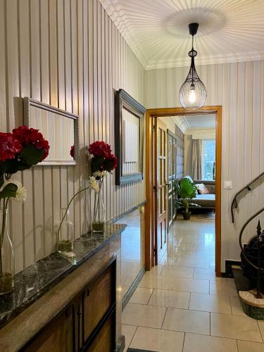 a hallway of a home with flowers on the counter at The Great View in Bouillon