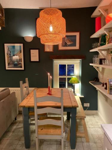 a dining room with a wooden table and chairs at The Folly in Sedbergh
