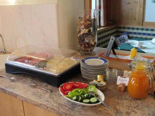 a counter with a tray of food and a bowl of vegetables at Haus Alpenglühn in Schladming