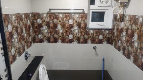 a bathroom with a sink and a toilet in a room at Aikya Kadri #Your Home Away from Home# non Smoke# Vegetarians Preferred# Strictly for Families in Mangalore