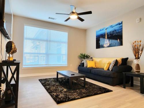 a living room with a couch and a ceiling fan at Short term rental in Charlotte