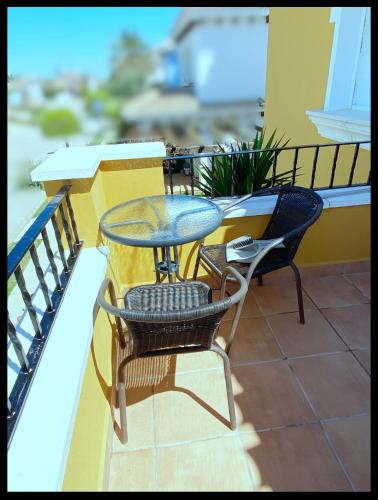 a table and chairs sitting on a balcony at Mar Menor Golf Villa - Frontline Detached - Heated Pool in Torre-Pacheco