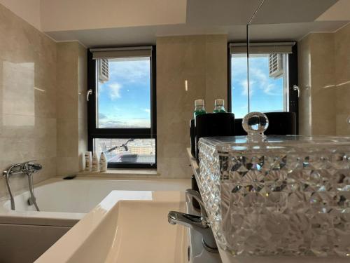 a bathroom with a bath tub and a sink at City View Apartament in Iaşi