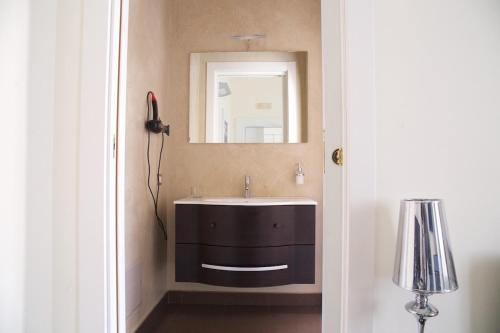 a bathroom with a sink and a mirror at Apollo Suites in Lecce