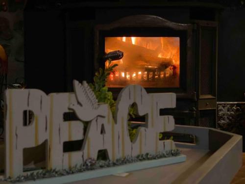 a fire in a fireplace with the word fire in front of it at Peaceful Gateway to Island Creek Cottage in East Stroudsburg