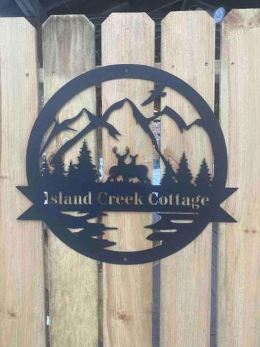 a sign for island creek college on a wooden fence at Peaceful Gateway to Island Creek Cottage in East Stroudsburg