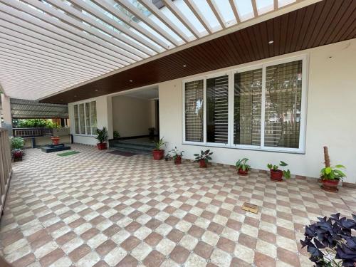 a patio with potted plants and a ceiling at Aikya Kadri #Your Home Away from Home# non Smoke# Vegetarians Preferred# Strictly for Families in Mangalore