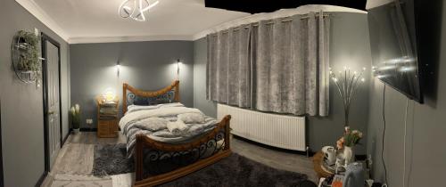 a bedroom with a large bed and a window at Da Vinci Guest House & Guest Parking, A Real Gem in Crawley