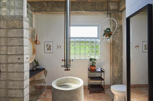 a bathroom with a large tub in the middle of a room at DADA JAJA by DW in San Juan