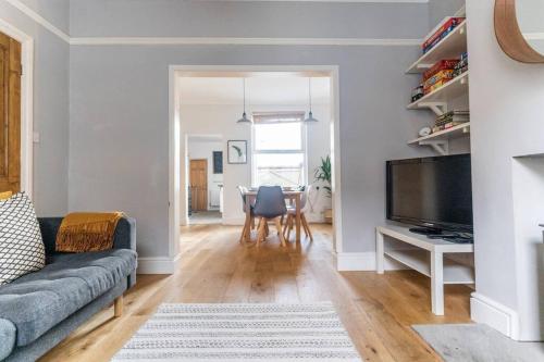 a living room with a couch and a tv at Spacious 3 Bedroom House York in York