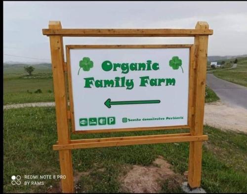a sign for an organic family farm on the side of a road at Organic Family Farm in Žabljak