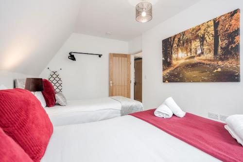 a bedroom with two beds and a painting on the wall at Comfortable 2BR Apartment in Bedford in Bedford