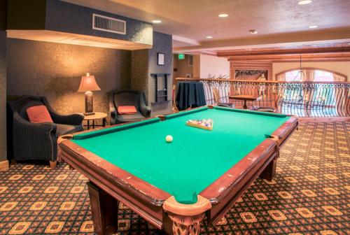 a pool table in a living room with a pool table at Villas at Zermatt Resort - Condos in Midway