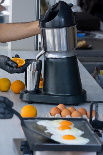 a mixer on a counter with eggs on a plate at Angels Pillow Luxury Boutique Residence - Adults Only in Naousa