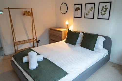 a bedroom with a bed with a cross on it at Calm Cosy House with Beautiful Riverside Walk to Centre in York