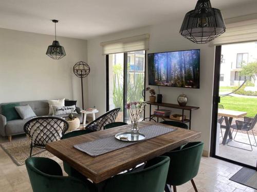 a living room with a wooden table and chairs at Depa planta baja en San Miguel de Allende in San Miguel de Allende