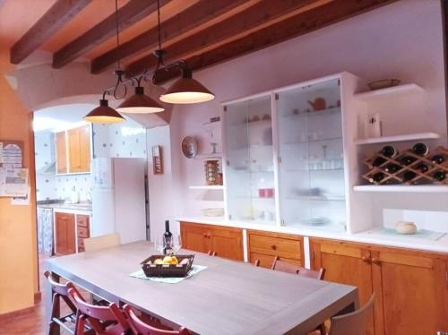 a kitchen with a table with chairs and cabinets at SOTIO, Village house in Campanet in Campanet