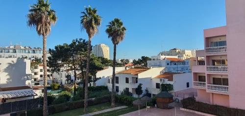 a view of a city with palm trees and buildings at Monte Gordo T1 Parque dos Reis in Monte Gordo