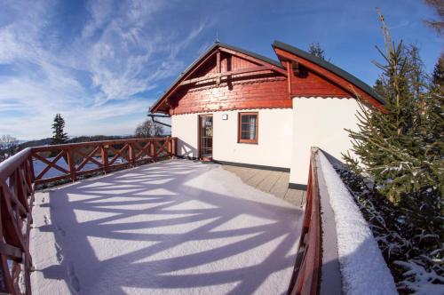 a bridge leading to a building with a house at Apartmán Benecko 213 in Benecko