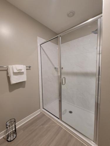 a shower in a bathroom with a glass shower stall at Short term rental in Charlotte