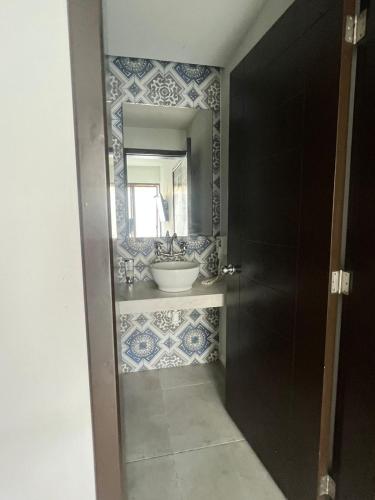 a bathroom with a sink and a mirror at Hotel MAYARI Holbox in Holbox Island