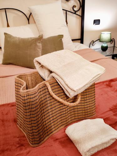 a bed with two towels sitting on top of it at il Sole di Baggio in Milan