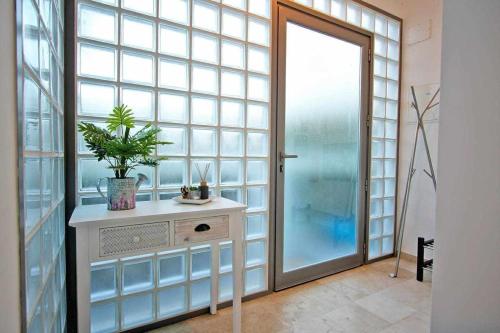 a bathroom with a large window and a sink with a plant at Believe in Dream Apart. Contemporâneo com Piscina in Tavira