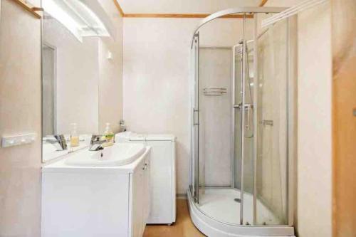 a bathroom with a shower and a sink at 36 sqm Studio aparatment B in Tromsø