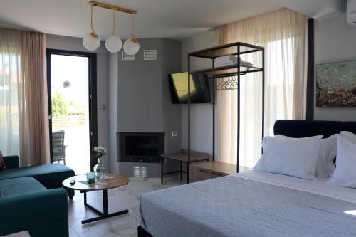 a bedroom with a bed and a couch and a tv at OLYMPUS Paradise 6 in Skotina