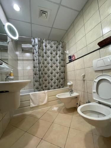 a bathroom with a toilet and a sink and a shower at Sea View 1BR apartment - Marina Pinnacle in Dubai