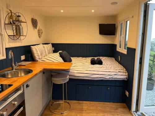 a small bedroom with a bed in a tiny house at Ramblers retreat in Shrewsbury