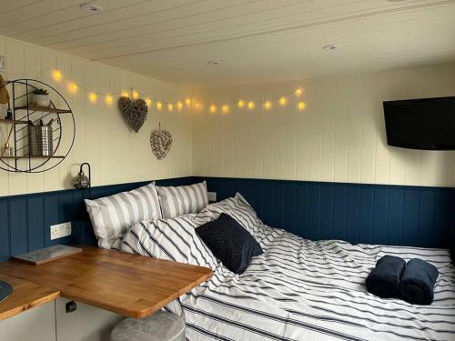 a bedroom with a bed and a wooden table at Ramblers retreat in Shrewsbury