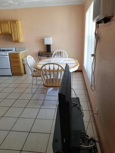 a kitchen with a table and a tv in a room at Old Wooden Bridge Resort & Marina in Big Pine Key