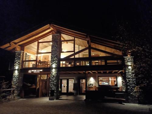 a large building with glass windows at night at Maison Bionaz Ski & Sport in Aosta