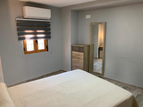 a bedroom with a bed and a mirror at Casa Antonia in Cazorla