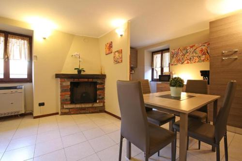 a dining room with a table and a fireplace at Bellagio Apartment San Giovanni in Bellagio