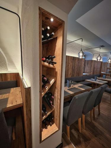 a restaurant with a wine cellar with tables and chairs at Hotel Rio Bianco in Panchia