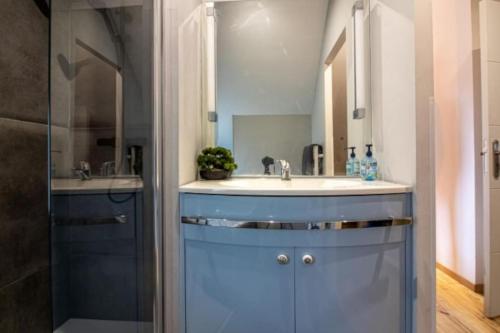 a bathroom with a sink and a mirror at Eden des Pyrénées in Arcizans-Avant