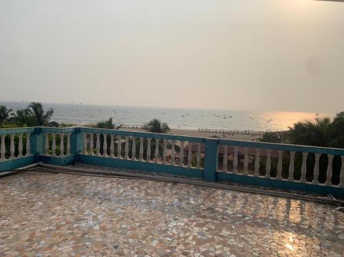 a blue fence on the beach with the ocean in the background at Hotel Ocean Face, BAGA in Baga