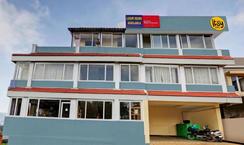 a building with a motorcycle parked in front of it at Itsy By Treebo - Rain Forest in Ooty