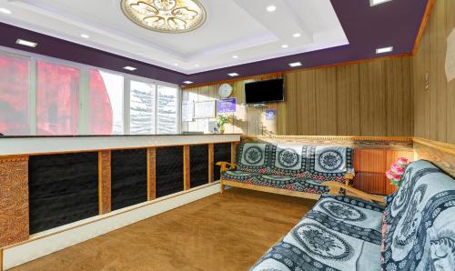 a waiting room with a couch and a bar at Itsy Hotels Rain Forest in Ooty