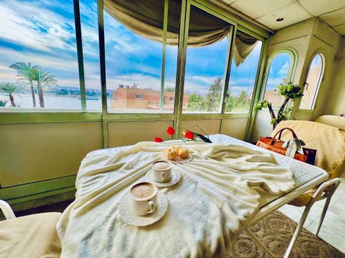 A bed or beds in a room at East Luxor Apartments with Nile views