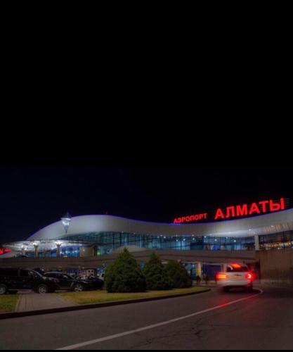 a building with a car driving in front of it at Аэропорт Алматы in (( Turksib ))